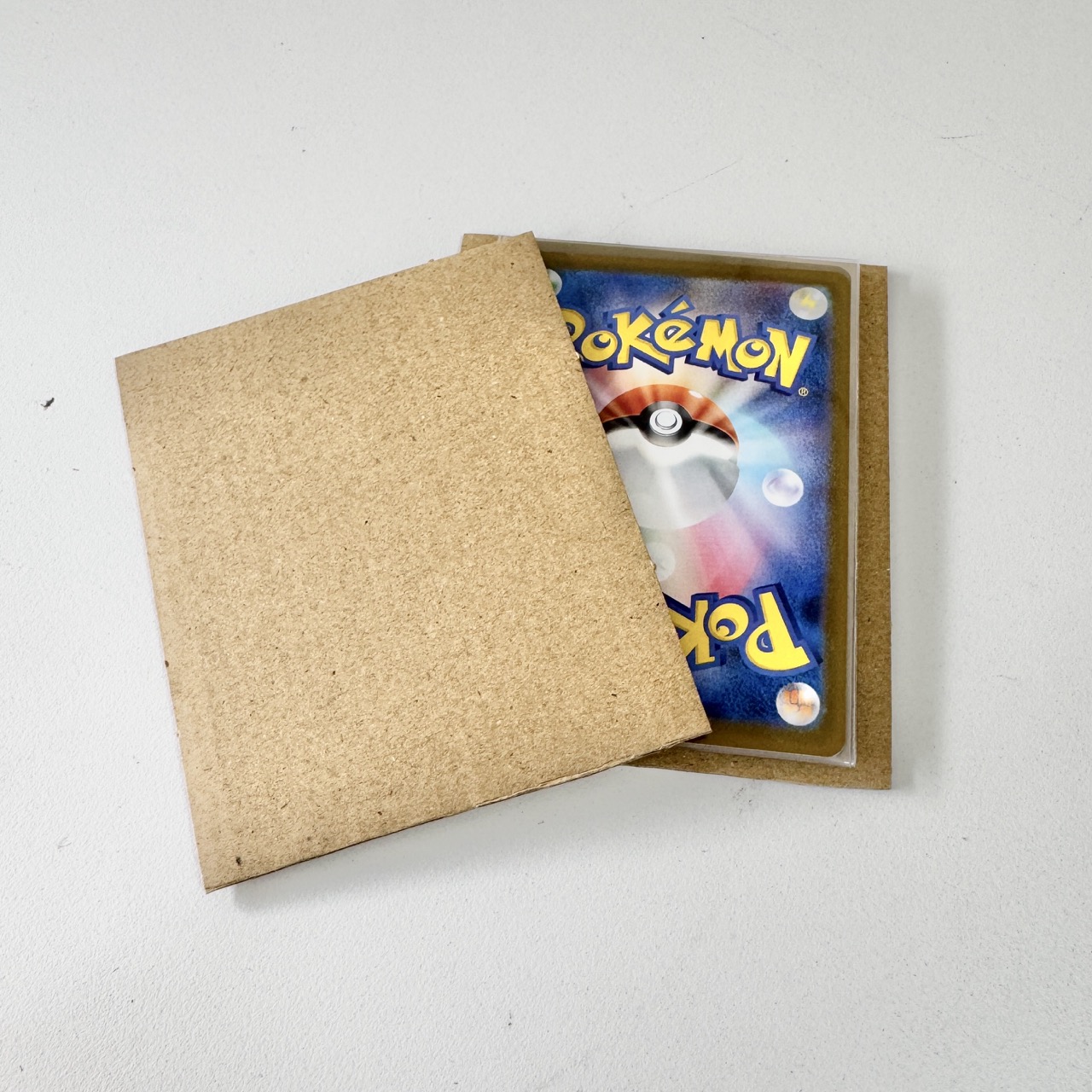 Rigid chipboard panels sandwich the cards to stop bending.
