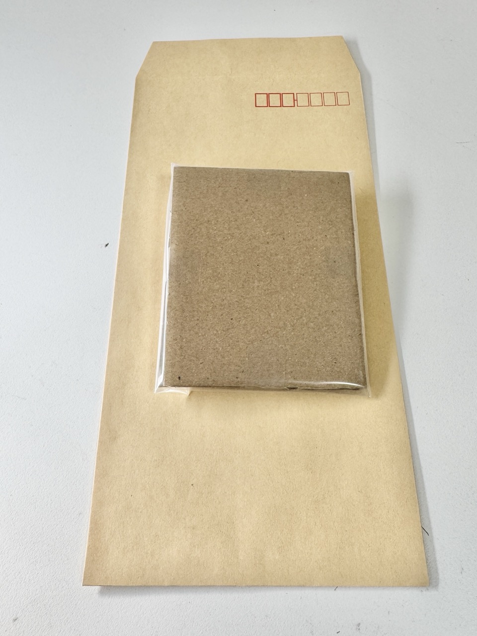 Protected cards slide into a sturdy kraft envelope.